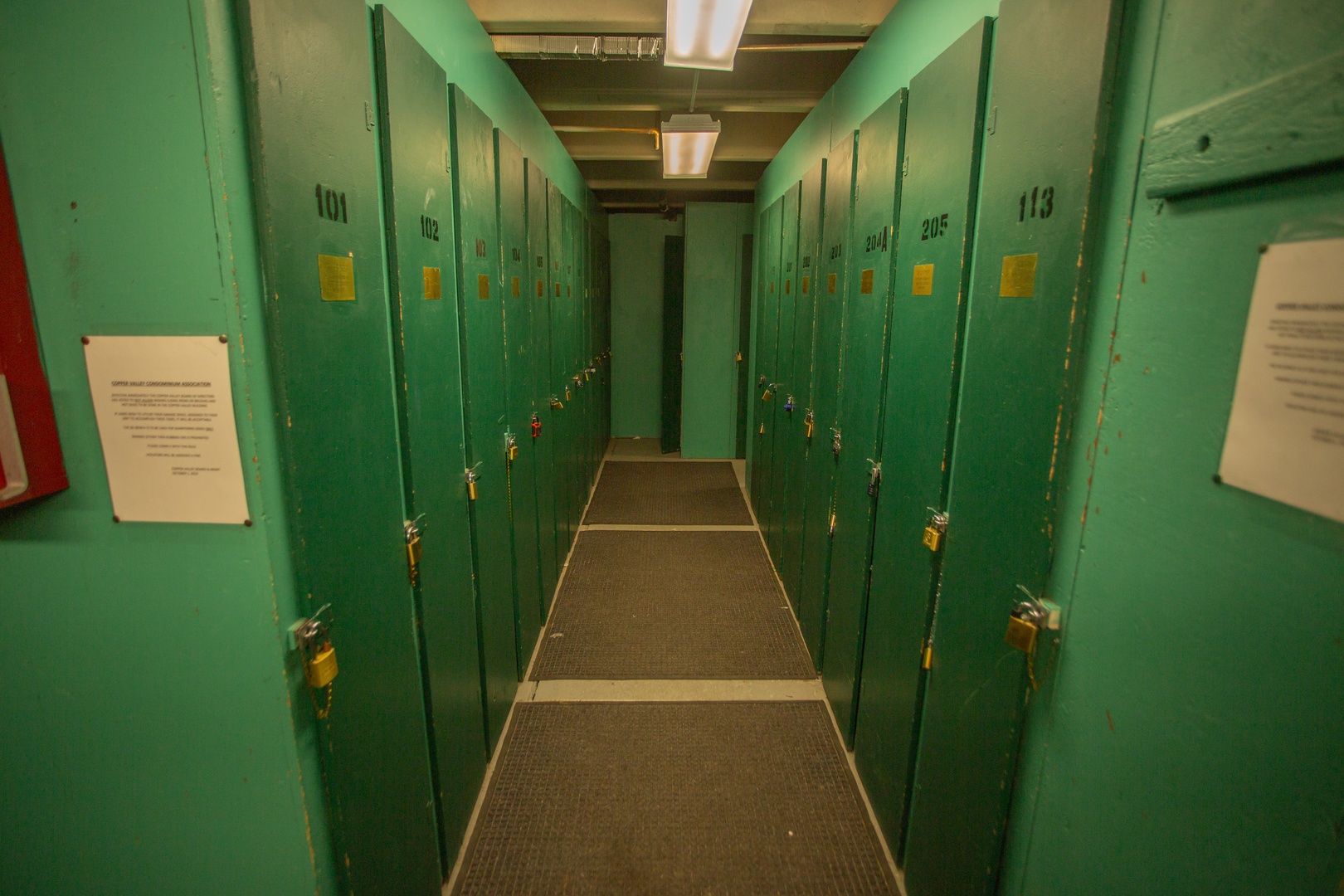 Green lockers line the hallway, offering secure storage for your belongings during your stay.