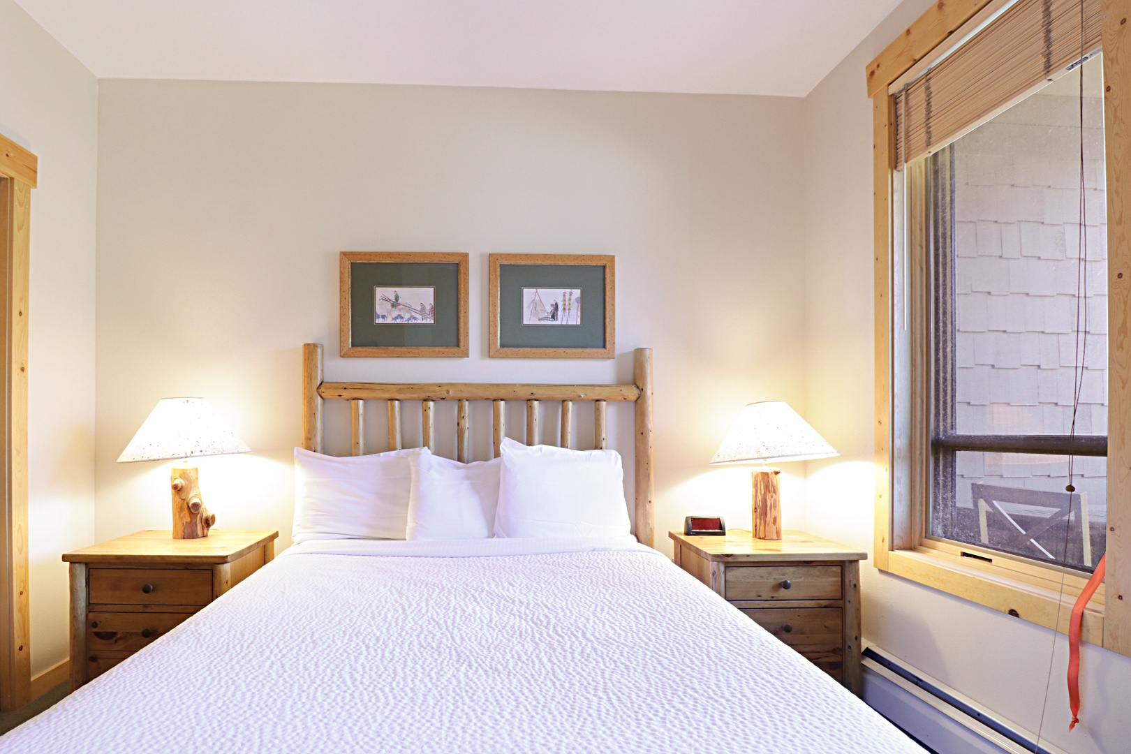 Sink into your cozy mountain retreat with rustic wood furnishings, crisp linens, and warm bedside lighting for perfect relaxation.