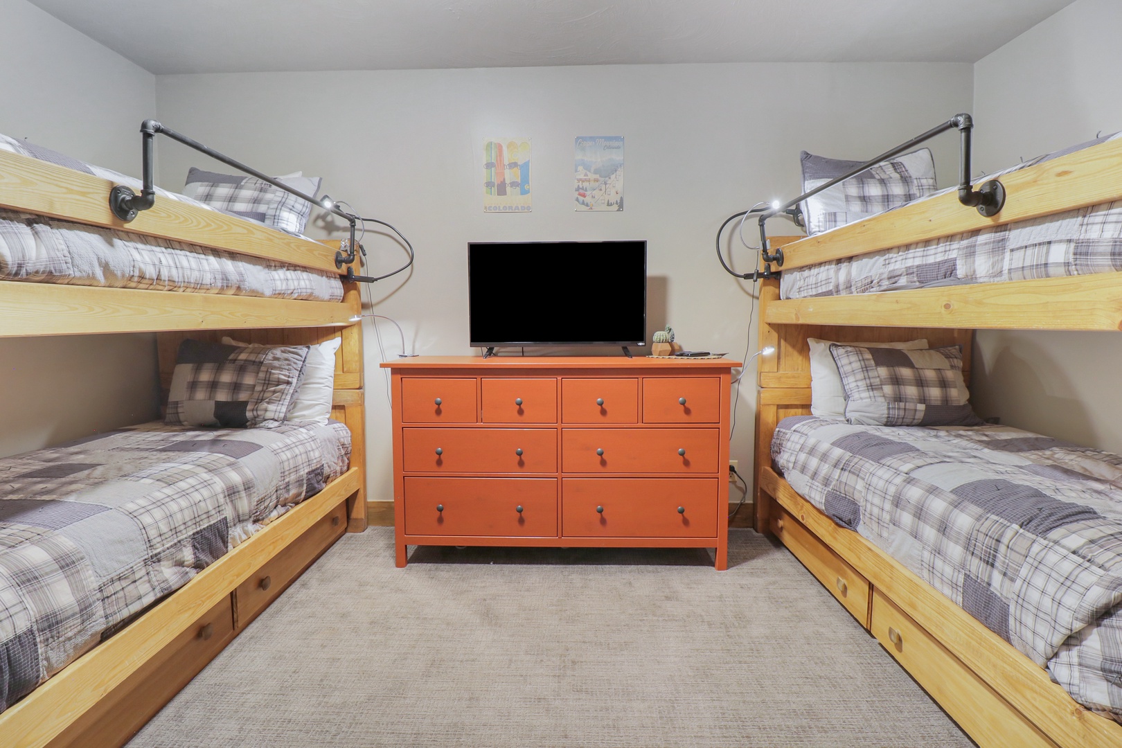 Your group will love this cheerful bunk room where adventure stories are shared and memories are made. Cozy plaid bedding and thoughtful reading lights make bedtime feel special for everyone.