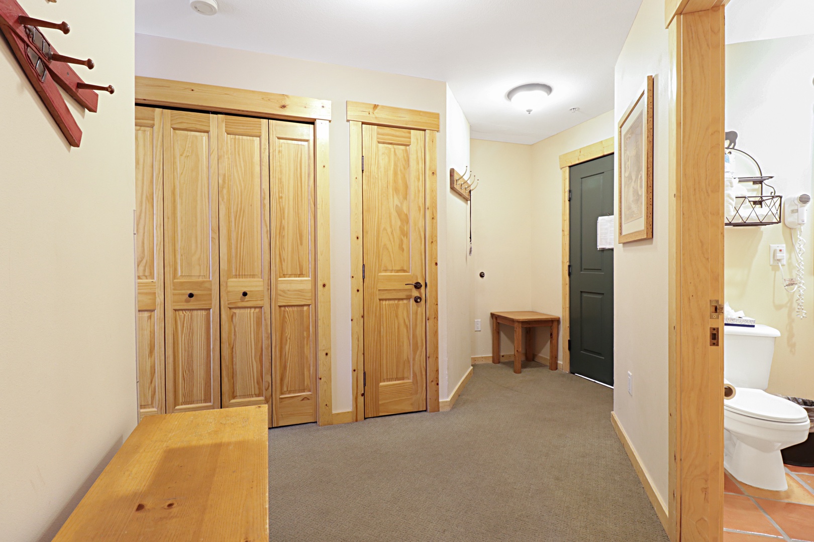 Your spacious hallway features beautiful wooden details and convenient storage, creating a warm welcome to your mountain retreat.