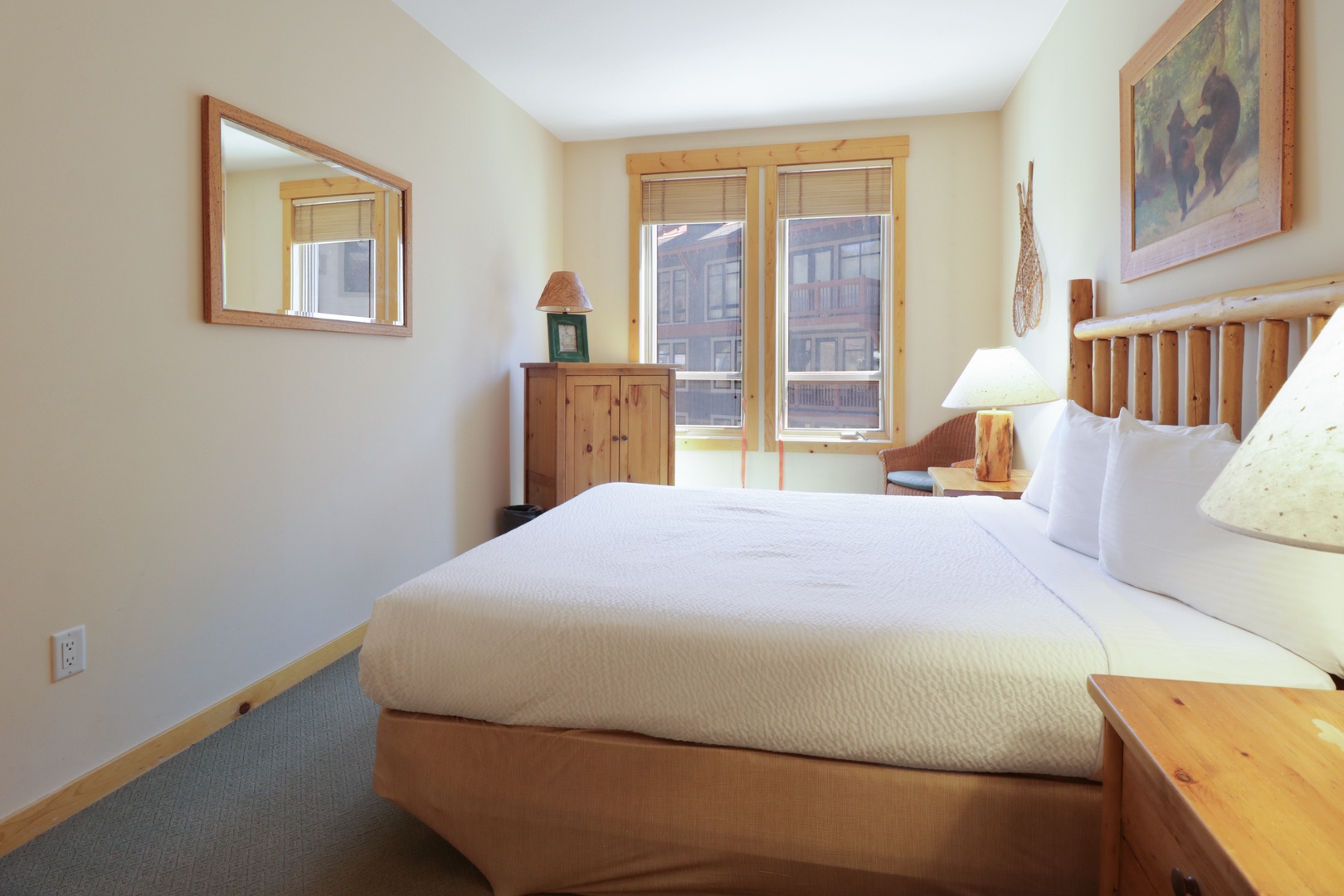 You'll love the crisp linens and warm wood accents that make this cozy bedroom your perfect mountain retreat sanctuary.