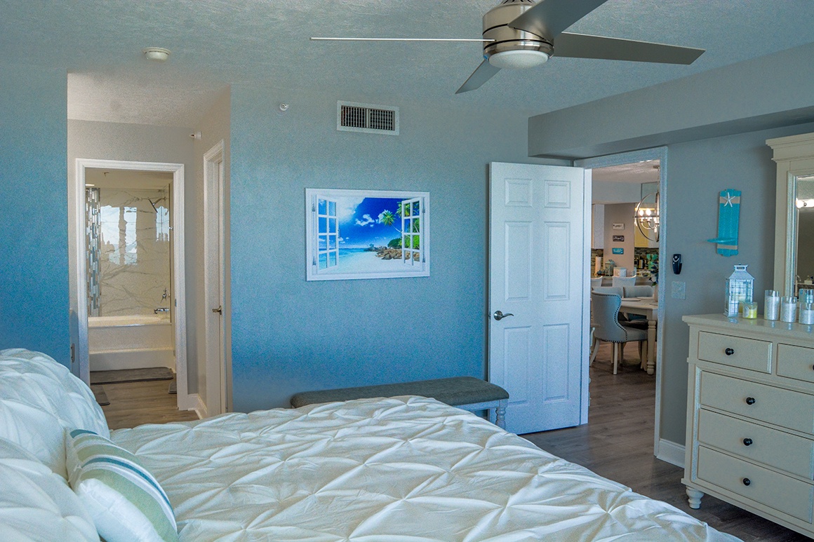 Rest peacefully in your coastal-themed bedroom with ocean-blue walls, crisp linens, and a ceiling fan to keep you comfortable throughout your stay.