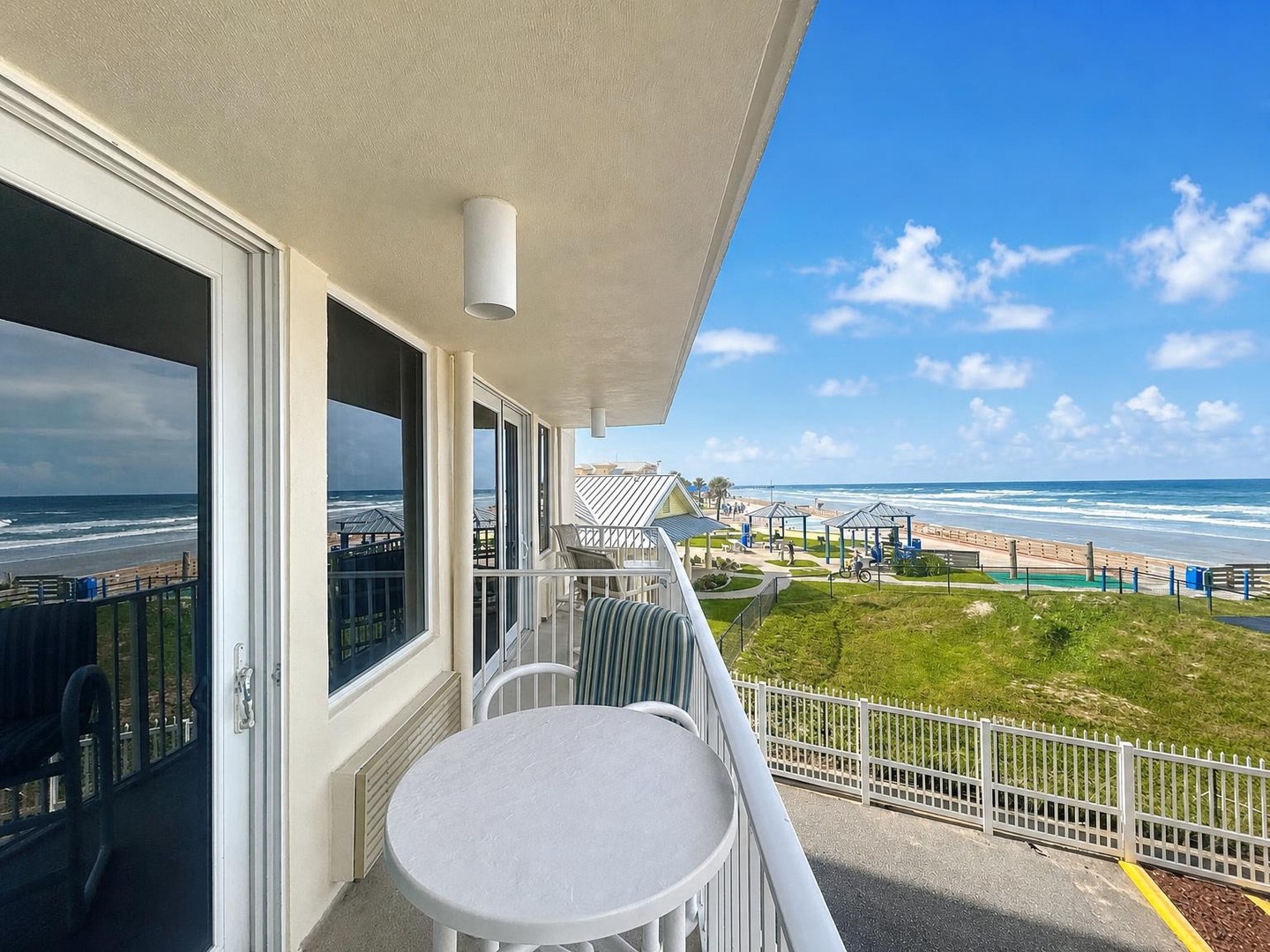 The beachfront balcony offers a panoramic ocean view where you can savor your morning coffee, breathe in the salty breeze, and watch waves roll in throughout your stay.