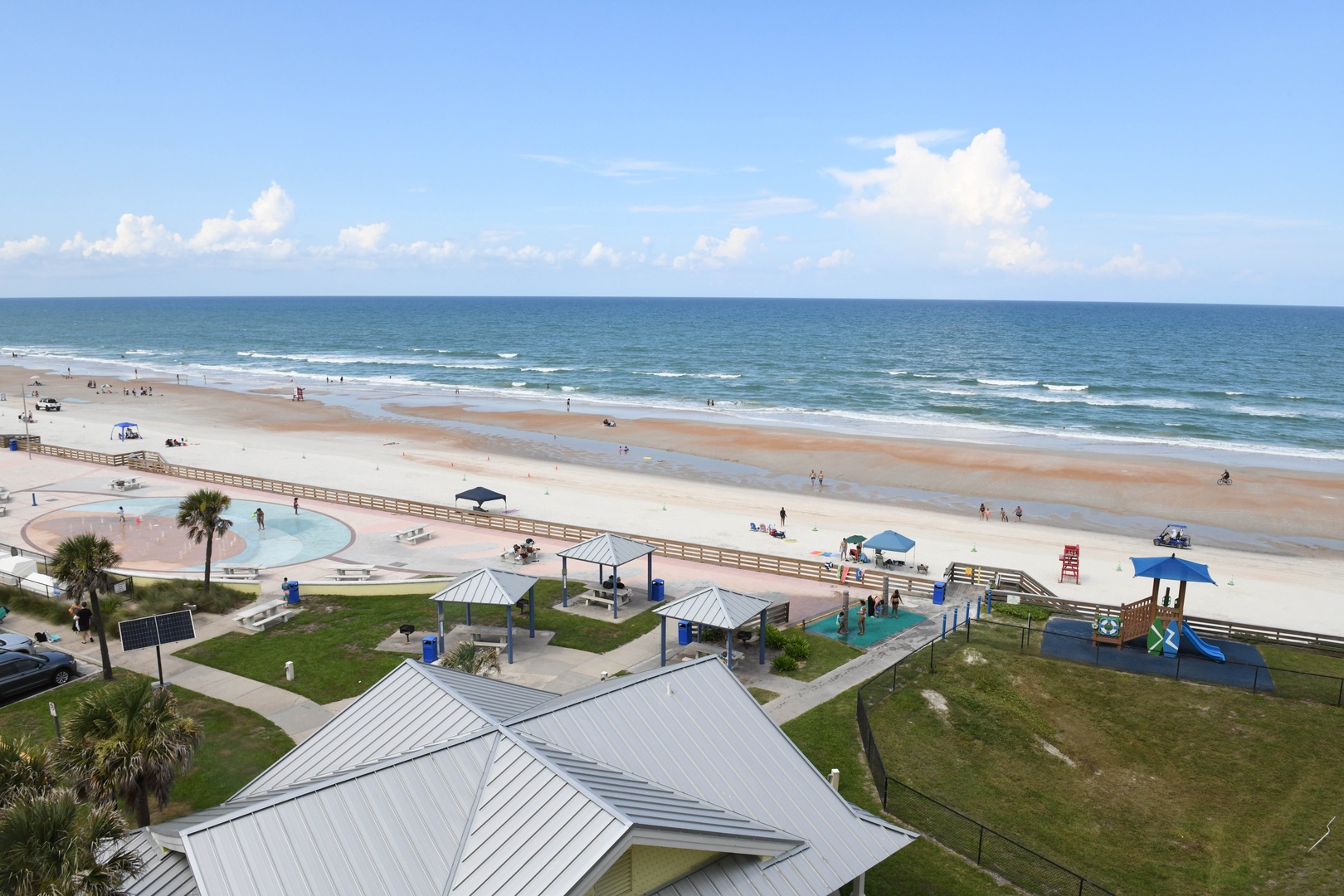 The property sits steps from a beautiful sandy beach with gentle waves and a family-friendly playground nearby, perfect for seaside relaxation.