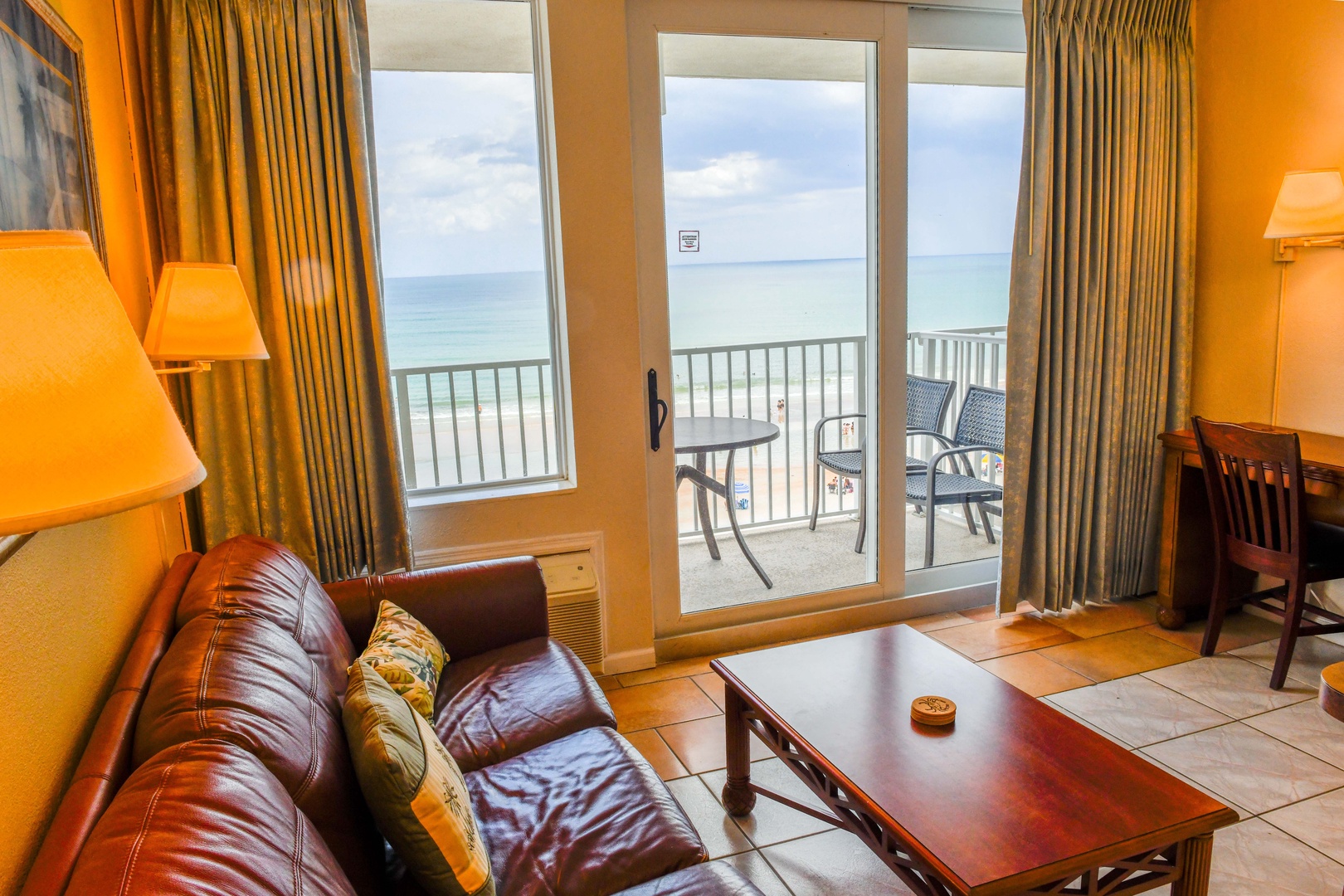 Sink into the plush sofa and gaze out at endless ocean views from your private balcony—your personal slice of coastal paradise awaits just steps away.