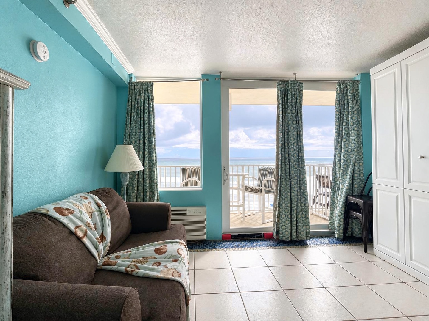 Step into your coastal retreat where turquoise walls and fresh sea breezes welcome you. Sink into the plush sofa, open the balcony doors, and let the ocean become your backdrop for total relaxation.