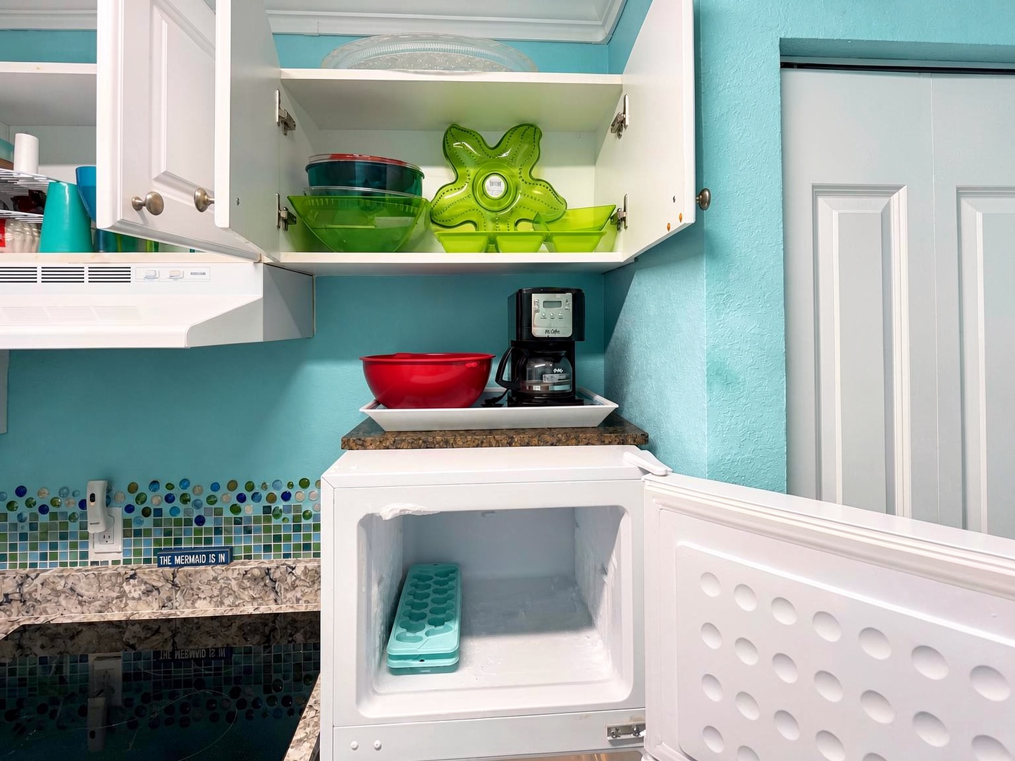 Your kitchenette comes stocked with cheerful dishes, a coffee maker for easy mornings, and a compact fridge to keep your snacks and drinks chilled throughout your stay.