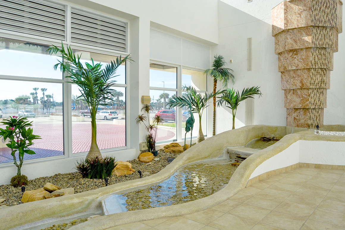 Sink into serenity in your private spa sanctuary, where tropical plants and flowing water create your personal wellness retreat.