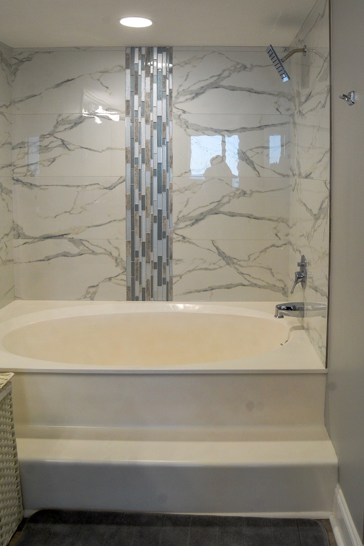 Sink into your marble sanctuary, where elegant tiles and glass doors create a spa-like retreat for ultimate relaxation.