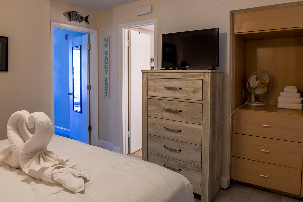 Unwind in your thoughtfully appointed bedroom with coastal touches and modern conveniences for a peaceful night's rest.