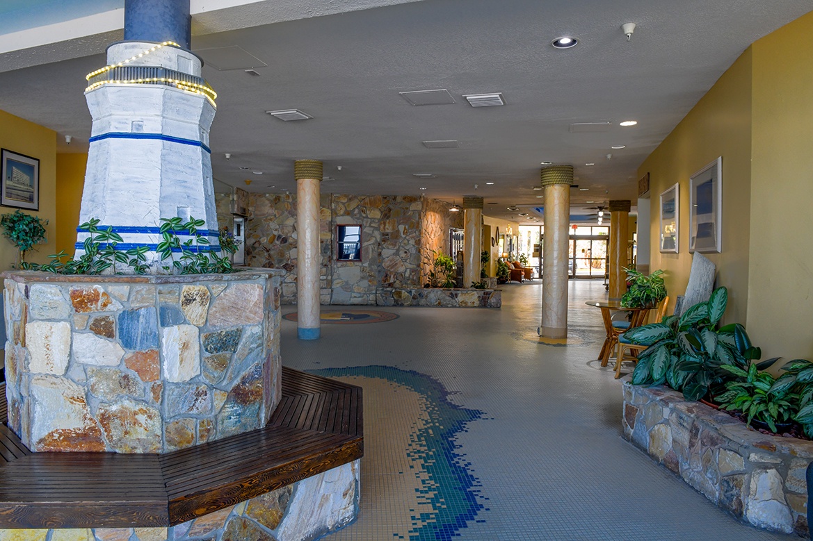 Step into a welcoming lobby where coastal charm meets comfort, featuring a charming lighthouse centerpiece and cozy seating areas.