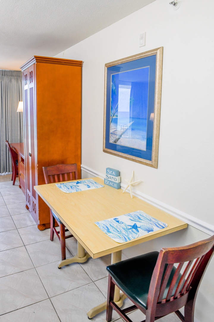 Your dining space features coastal-inspired artwork and comfortable seating where you can enjoy meals together while planning your beach adventures.