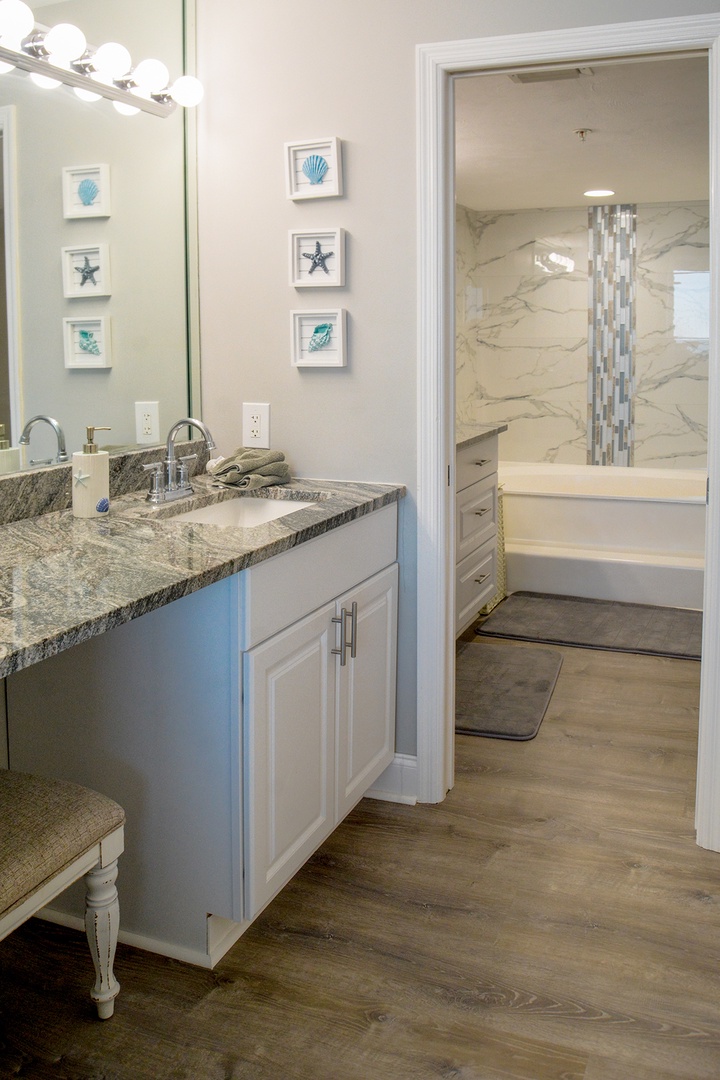 Your elegant bathroom features granite counters and coastal charm, with a luxurious marble shower awaiting your relaxation.