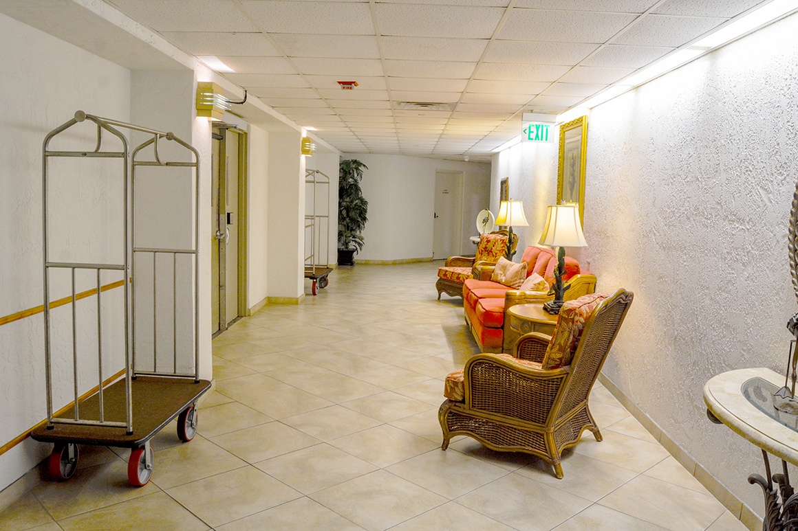 Settle into comfortable wicker chairs in your lobby lounge area, where warm lighting and tropical touches create a welcoming atmosphere.