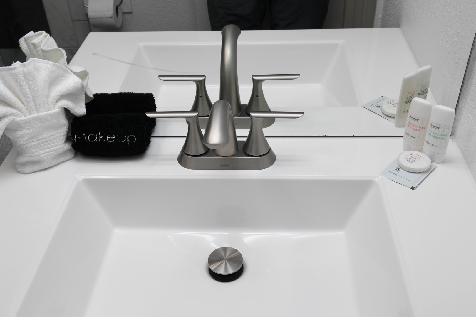 Your private bathroom sink comes stocked with fresh towels and thoughtful toiletries, ready for you to freshen up and feel at home during your stay.