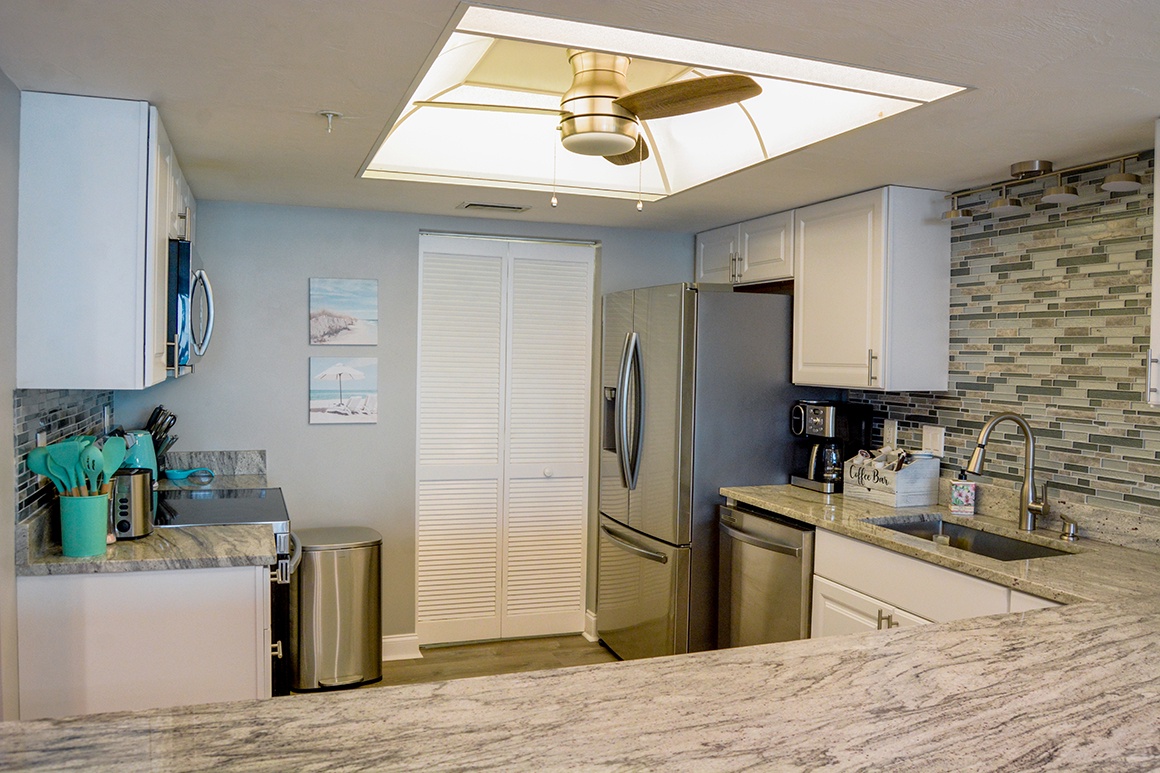 Your fully equipped kitchen features granite counters, stainless appliances, and a bright skylight for cooking memorable meals together.