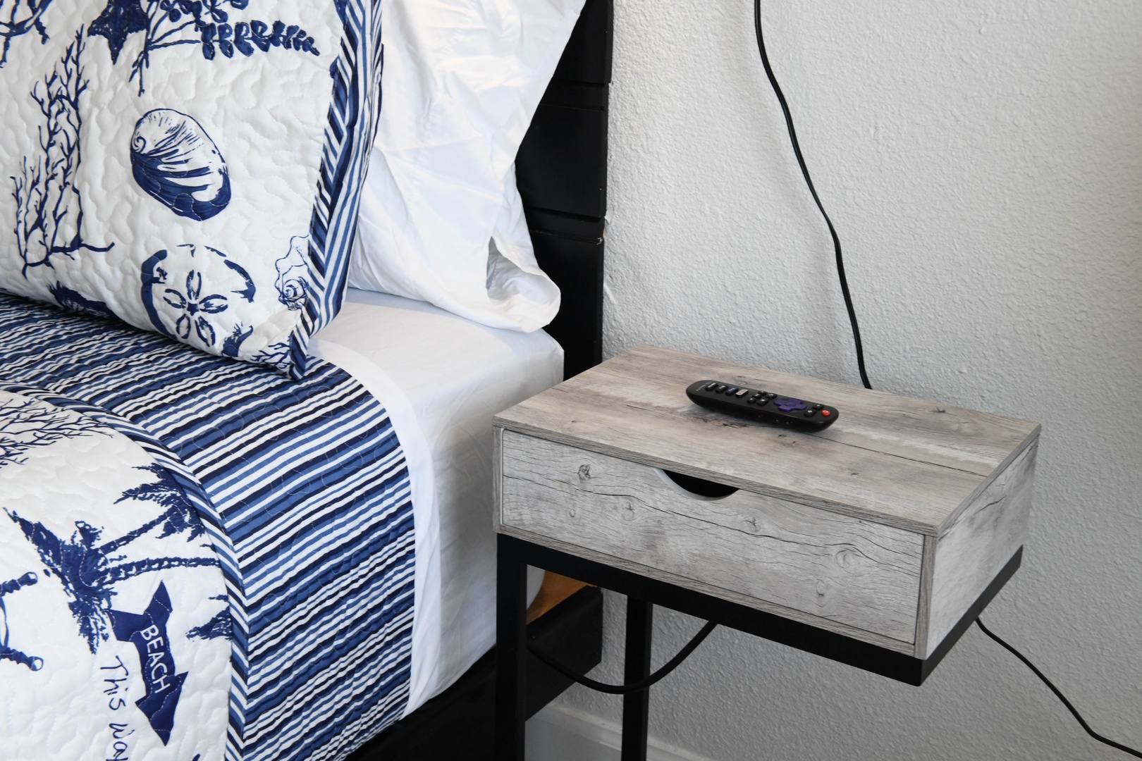 Sink into crisp linens and nautical charm with this modern nightstand at your bedside, where coastal dreams meet everyday comfort.