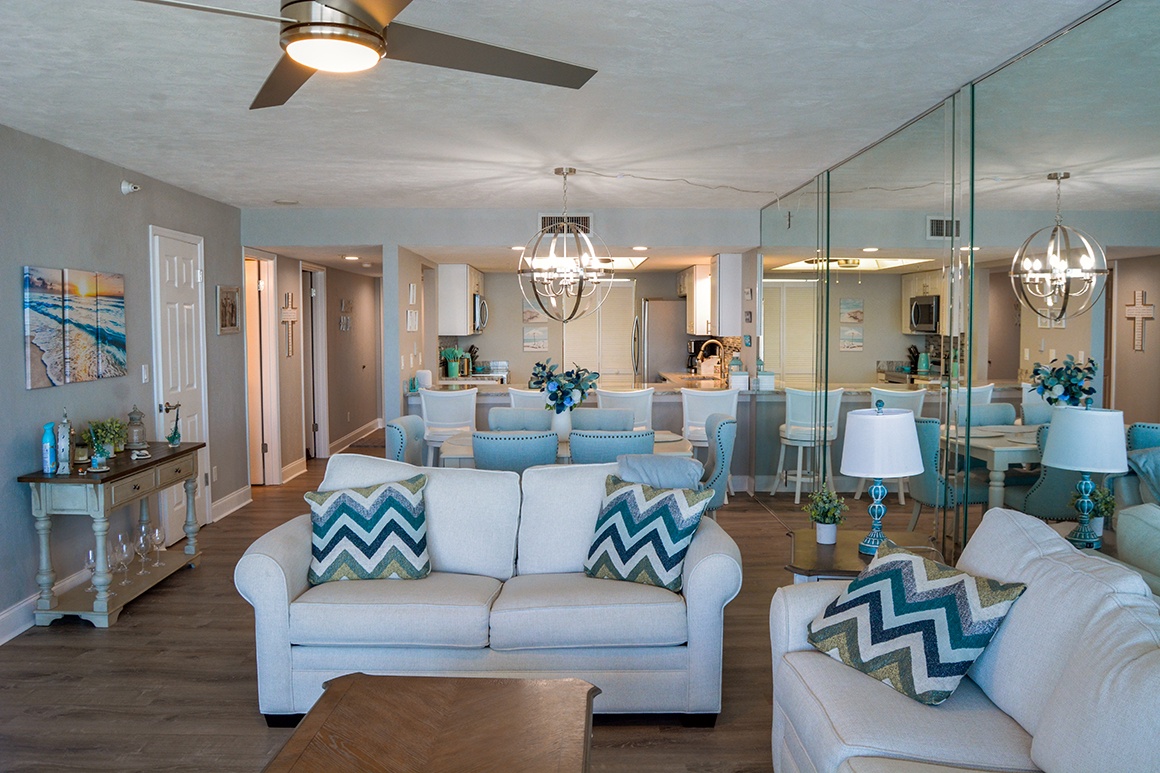 Relax in your bright open living space with stylish turquoise accents, comfortable seating, and coastal-inspired decor throughout.