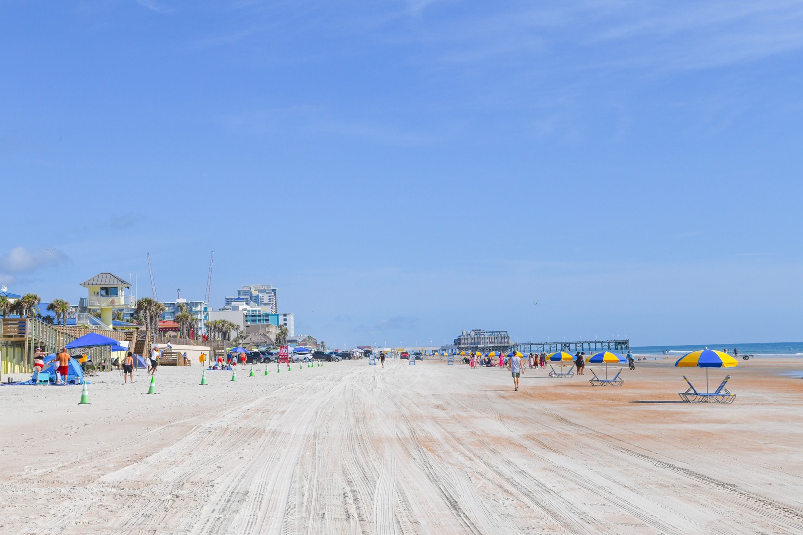 Expansive beachfront location offering easy access to soft sands and coastal attractions, with lifeguard station, pier, and beachside amenities nearby.
