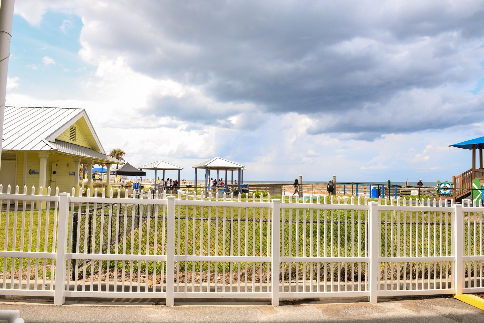 Beachfront property location with playground and covered pavilions along the shoreline, offering direct access to coastal recreation areas.