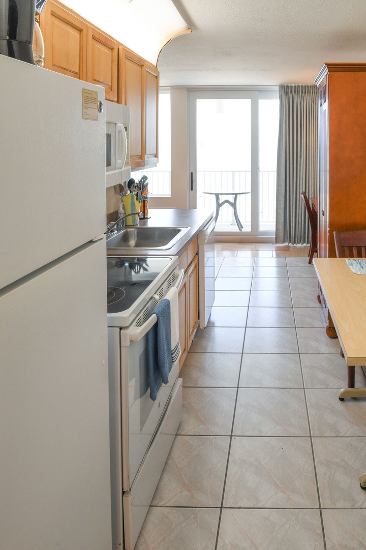 Your fully equipped kitchen offers everything you need to prepare meals at home, with modern appliances, ample counter space, and views of your private balcony just steps away.