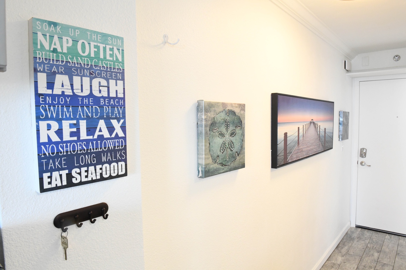 Coastal artwork and beachy décor welcome you at the entry, setting a relaxed, vacation vibe the moment you arrive. Your seaside escape starts here.