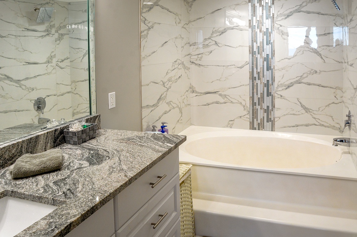 Luxurious marble bathroom with granite vanity and soaking tub for your ultimate relaxation retreat.