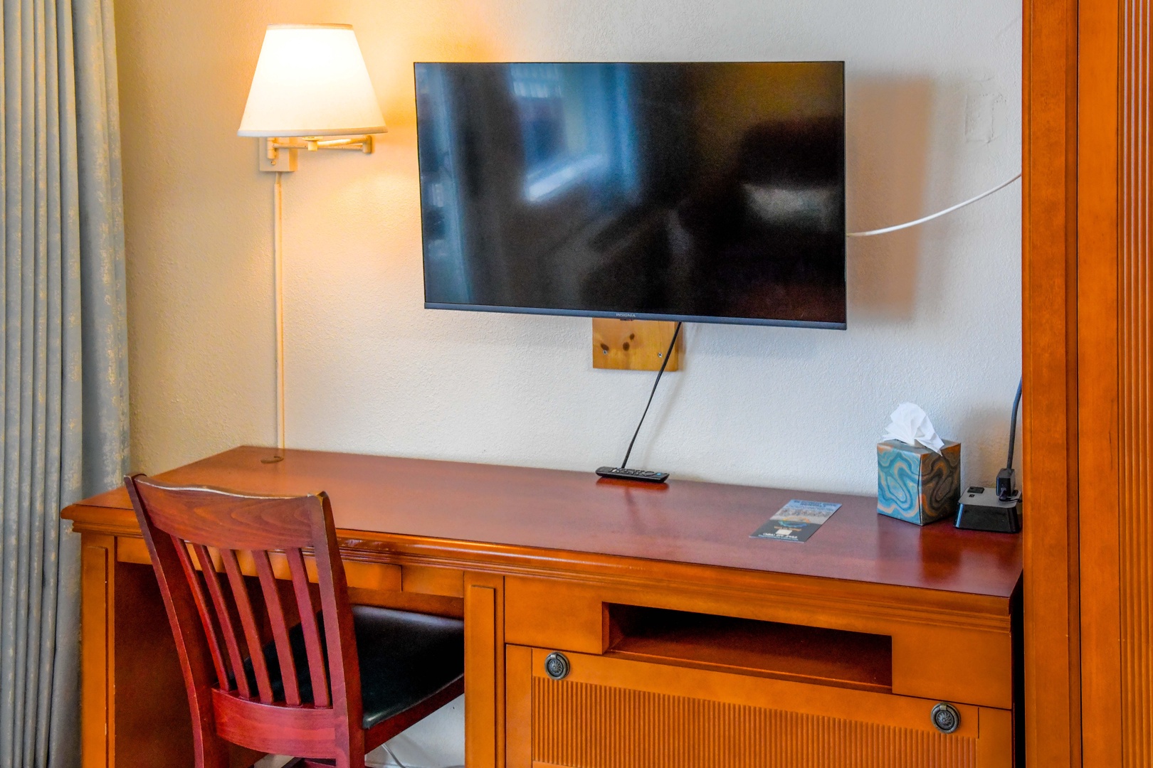 Your workspace awaits, complete with a spacious desk, warm lighting, and a flat-screen TV—perfect for catching up on work or unwinding after your adventures.