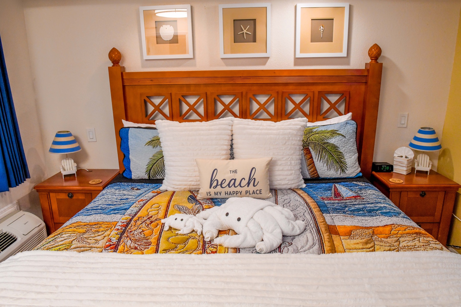 Your coastal retreat awaits: plush bedding with playful beach-themed pillows, charming nautical touches, and soft lighting create the perfect haven for relaxation after sun-soaked adventures.