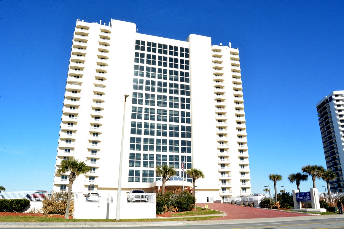 Modern high-rise vacation property featuring contemporary architecture with expansive glass windows and private balconies throughout multiple floors.