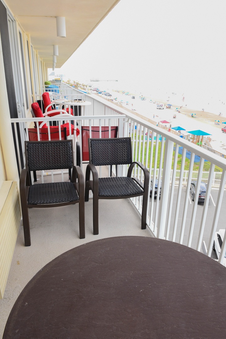 Step onto your private balcony and take in sweeping beach views, where the ocean breeze meets comfortable seating—perfect for morning coffee or sunset watching with the sand just steps away.