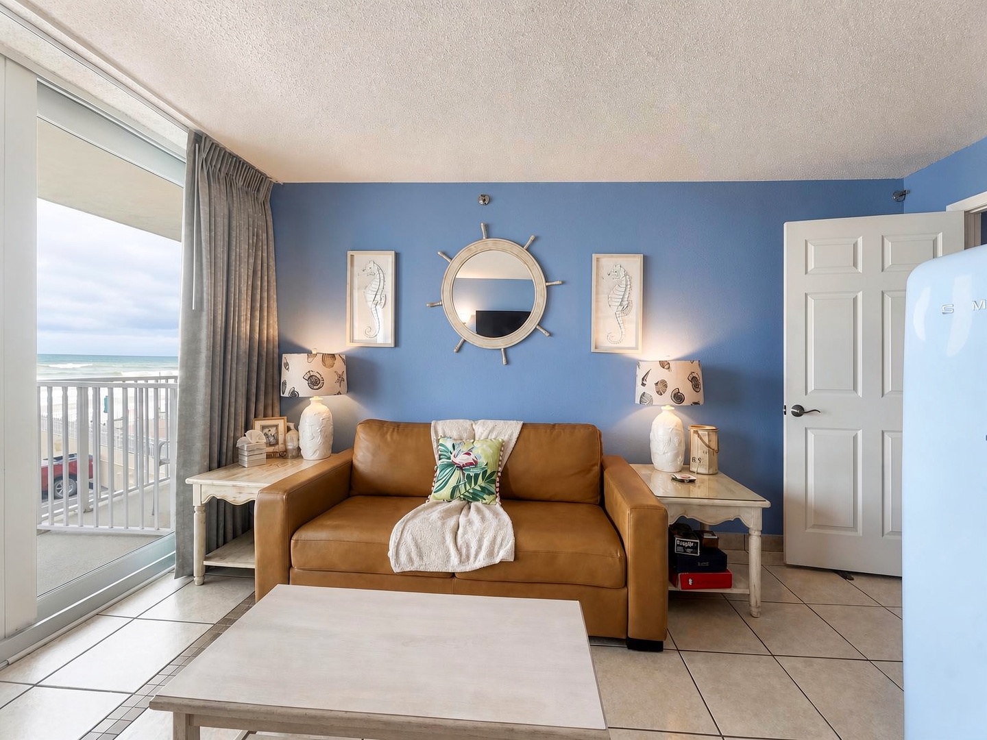 Step into your coastal retreat where beach-inspired blues and warm leather create the perfect spot to unwind. Through the sliding doors, your private balcony frames endless ocean waves—your front-row seat to sunrise coffee and salty breezes.