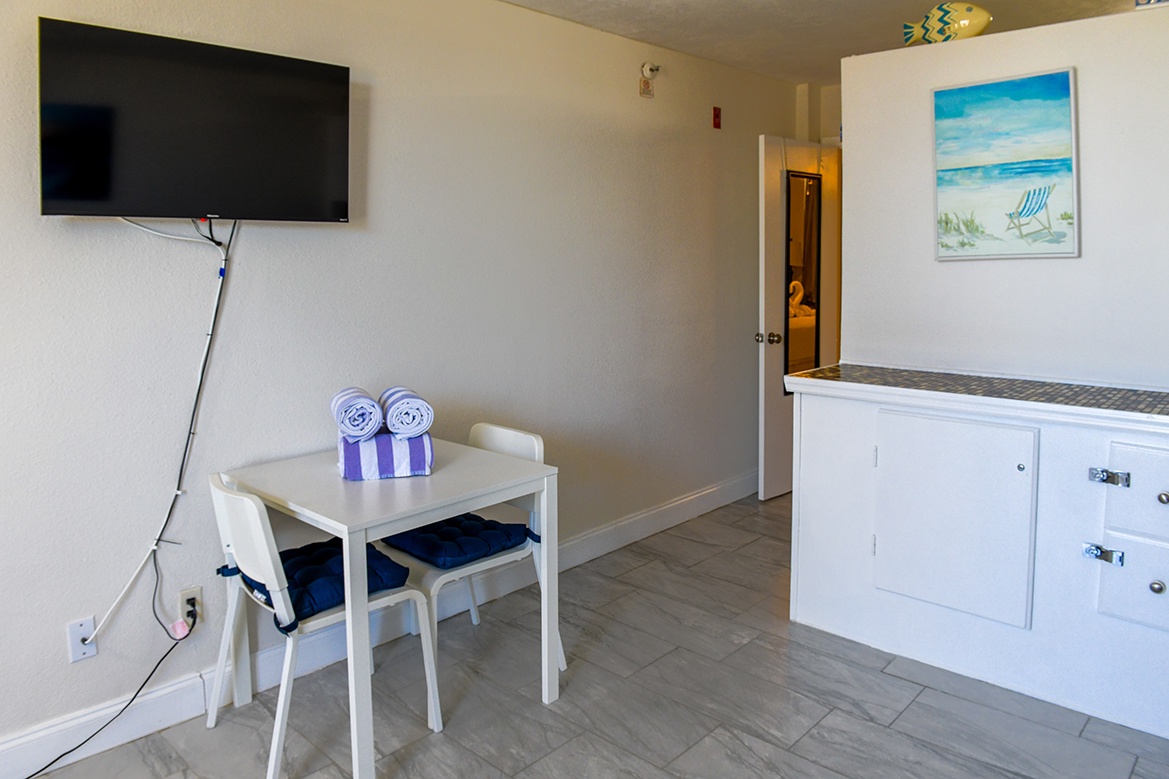 Relax at your cozy dining table while catching up on shows, with fresh towels ready for beach days ahead.