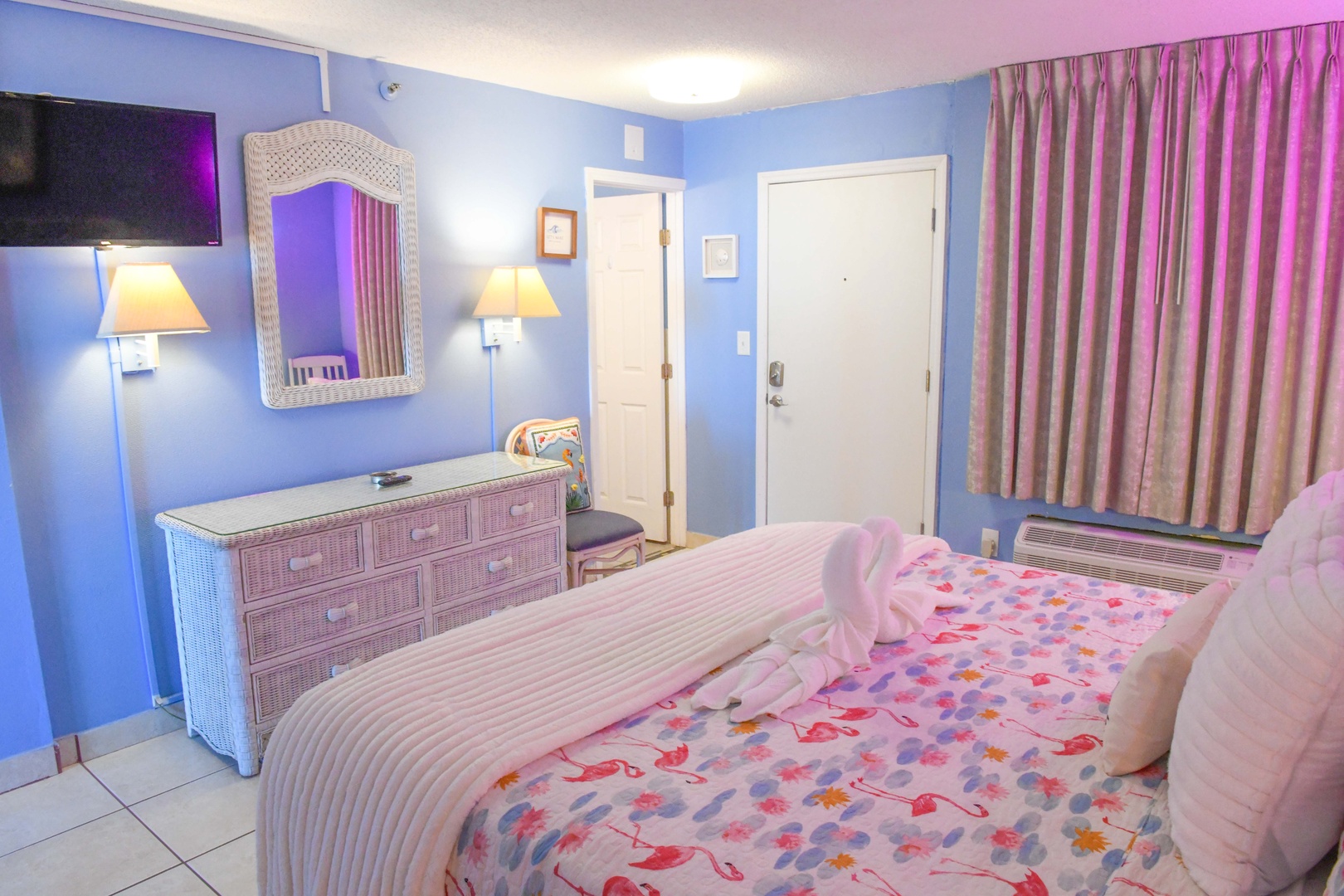 Unwind in your bright, welcoming bedroom featuring a plush bed, coastal-inspired décor, and all the comforts you need for a restful stay.