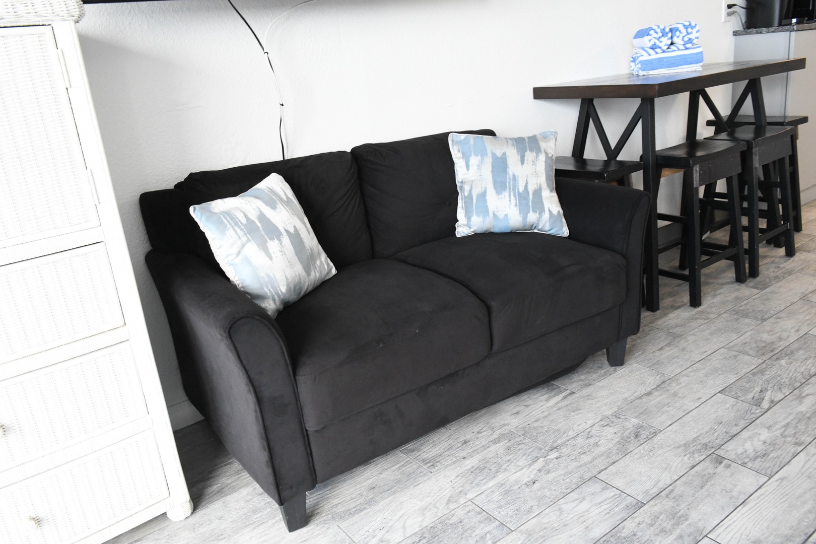Settle into this cozy living space with plush seating and stylish blue-patterned pillows, perfect for relaxing after your day of exploring.