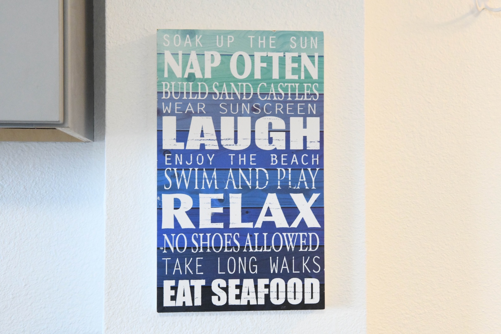 This welcoming sign sets the tone for a relaxed coastal getaway, promising sunny days, sandy beaches, and carefree seaside living throughout your stay.