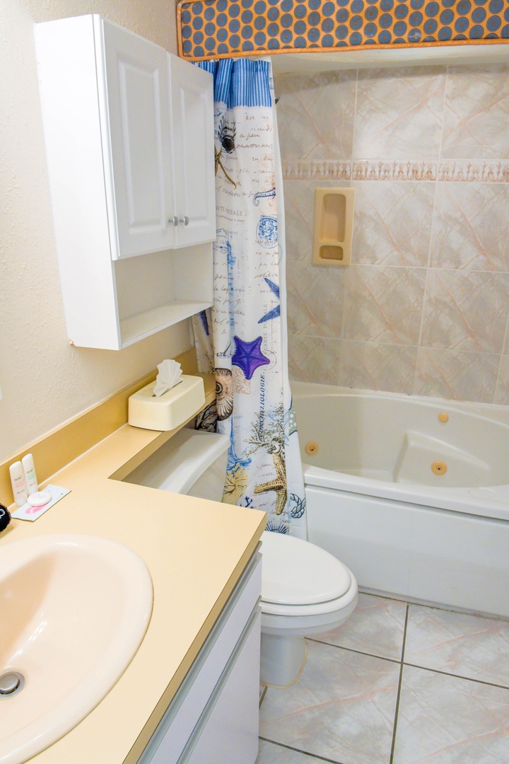 Relax in your full bathroom with a whirlpool tub and coastal-themed accents after a day of beach adventures. Fresh towels and toiletries are ready for you.