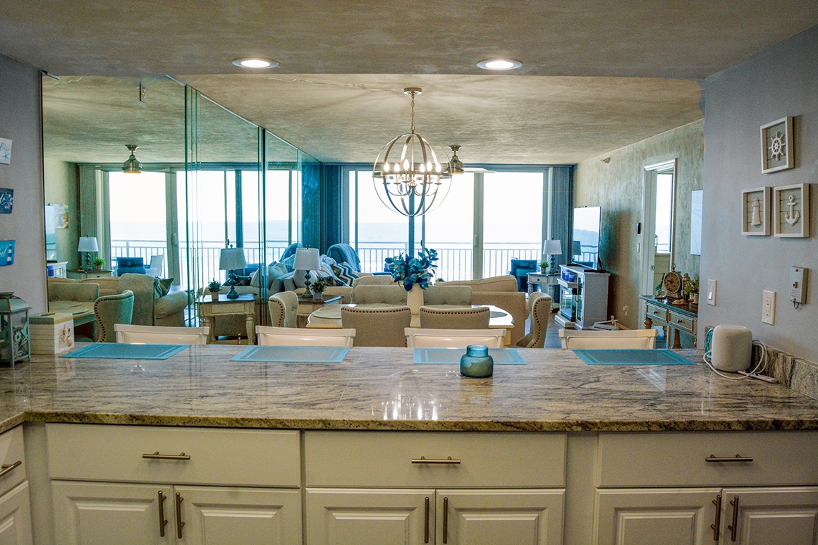 Your gourmet kitchen opens to stunning ocean views, where you'll cook with the sea as your backdrop through floor-to-ceiling windows.