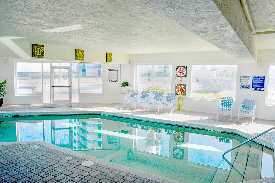 Dive into your private indoor oasis with crystal-clear waters, comfortable poolside seating, and dartboard entertainment.