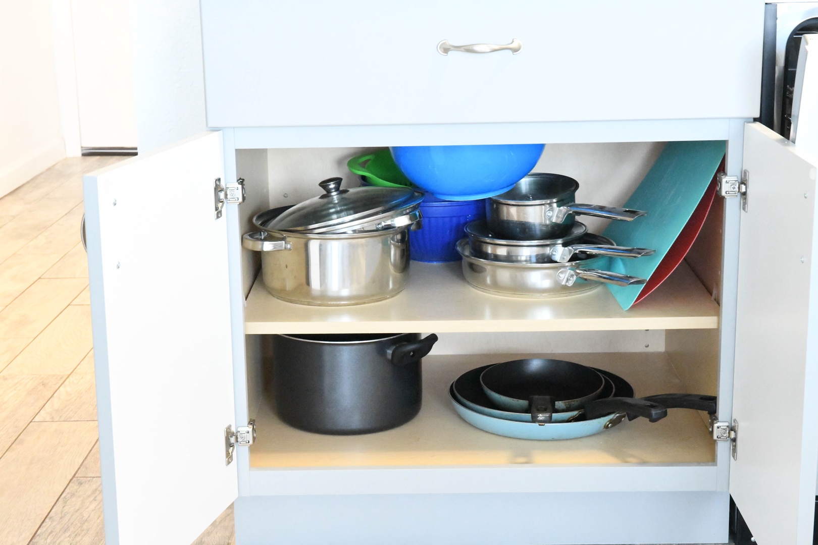 Your kitchen comes fully equipped with quality cookware and essentials neatly organized for your convenience.
