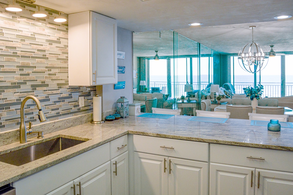 Cook and entertain with ease in this stunning coastal kitchen featuring granite countertops, modern appliances, and beautiful ocean views.