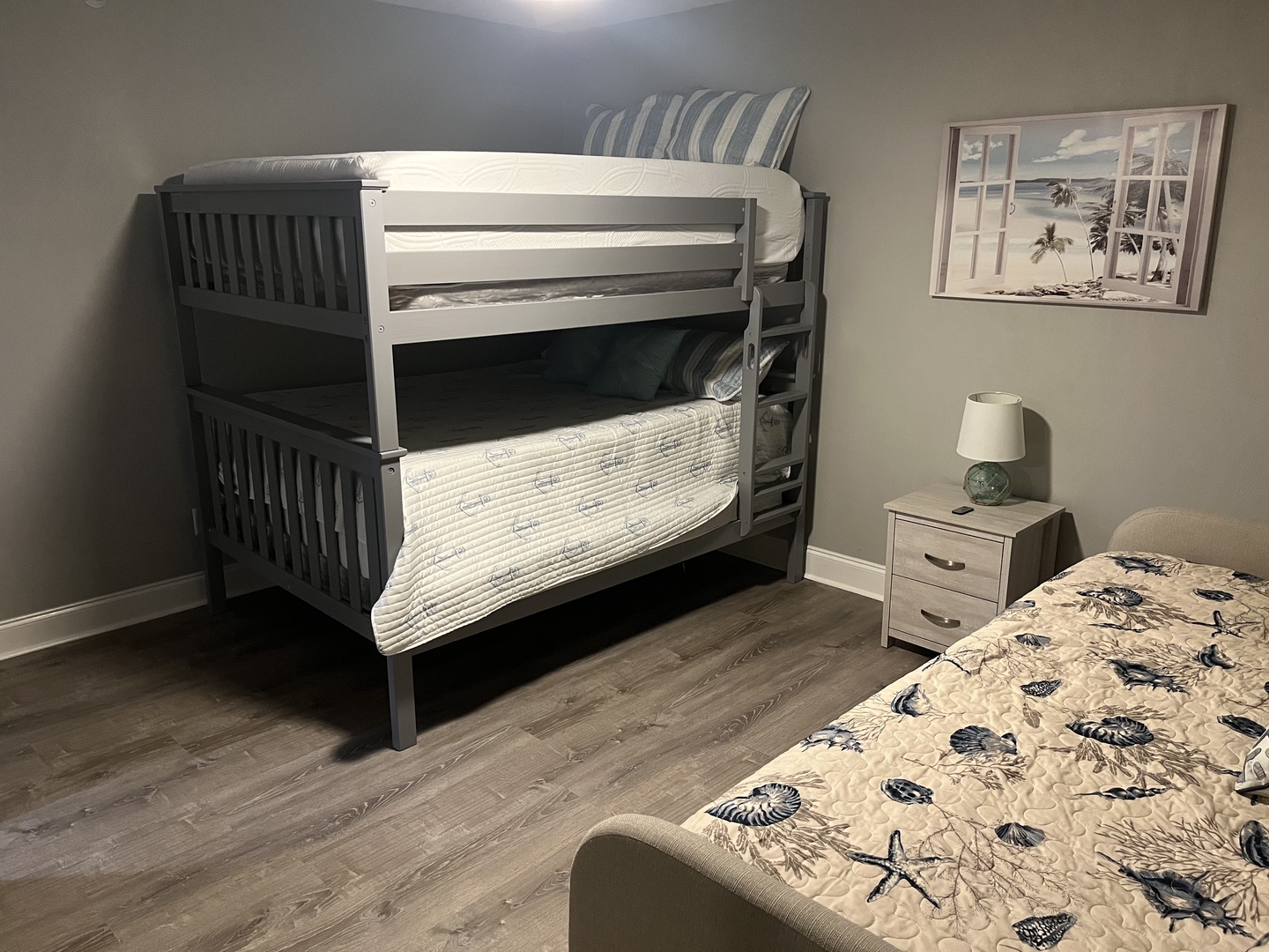 Your coastal-themed bedroom features cozy bunk beds and a comfortable queen bed, perfect for families with ocean-inspired décor.