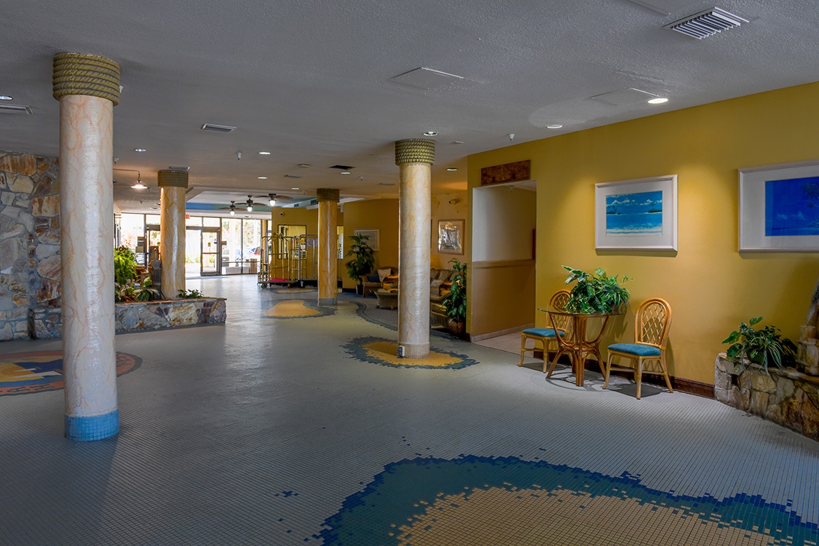 Step into this inviting indoor pool area where warm yellow walls and tropical artwork create your perfect relaxation retreat.