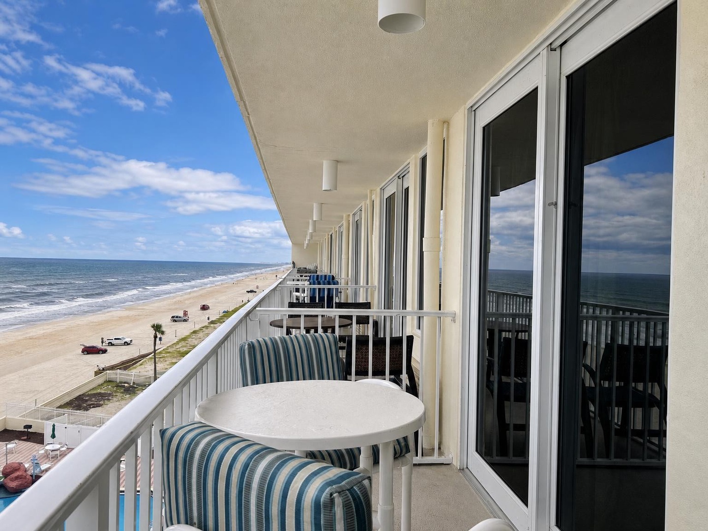 Step onto your private balcony and breathe in the salt air as waves roll gently onto the sand below. This is your front-row seat to the ocean, with space to savor morning coffee or evening sunsets just beyond the railing.