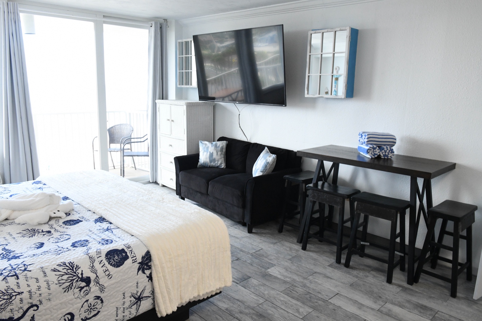 Relax in your bright coastal-style studio with a comfy sofa, flat-screen TV, and private balcony where you can enjoy morning coffee or evening unwinding with ocean breezes.