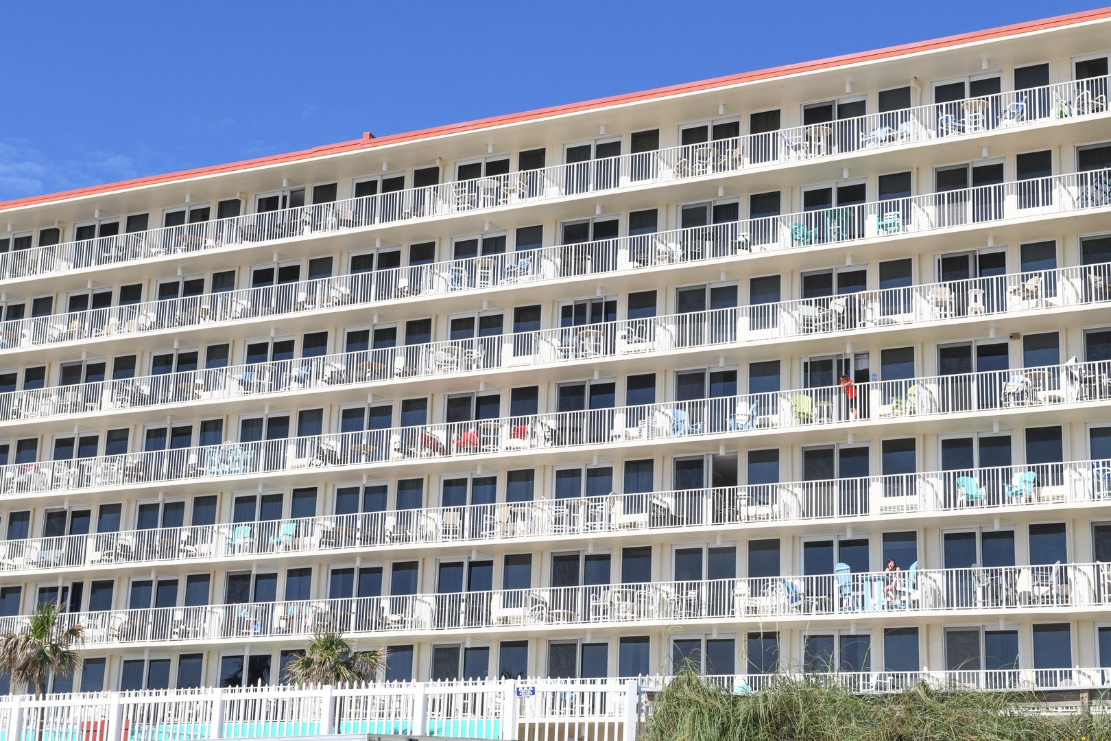 Multi-story beachfront property featuring spacious rooms with private balconies, offering easy access to sun, sand, and coastal breezes from nearly every level.
