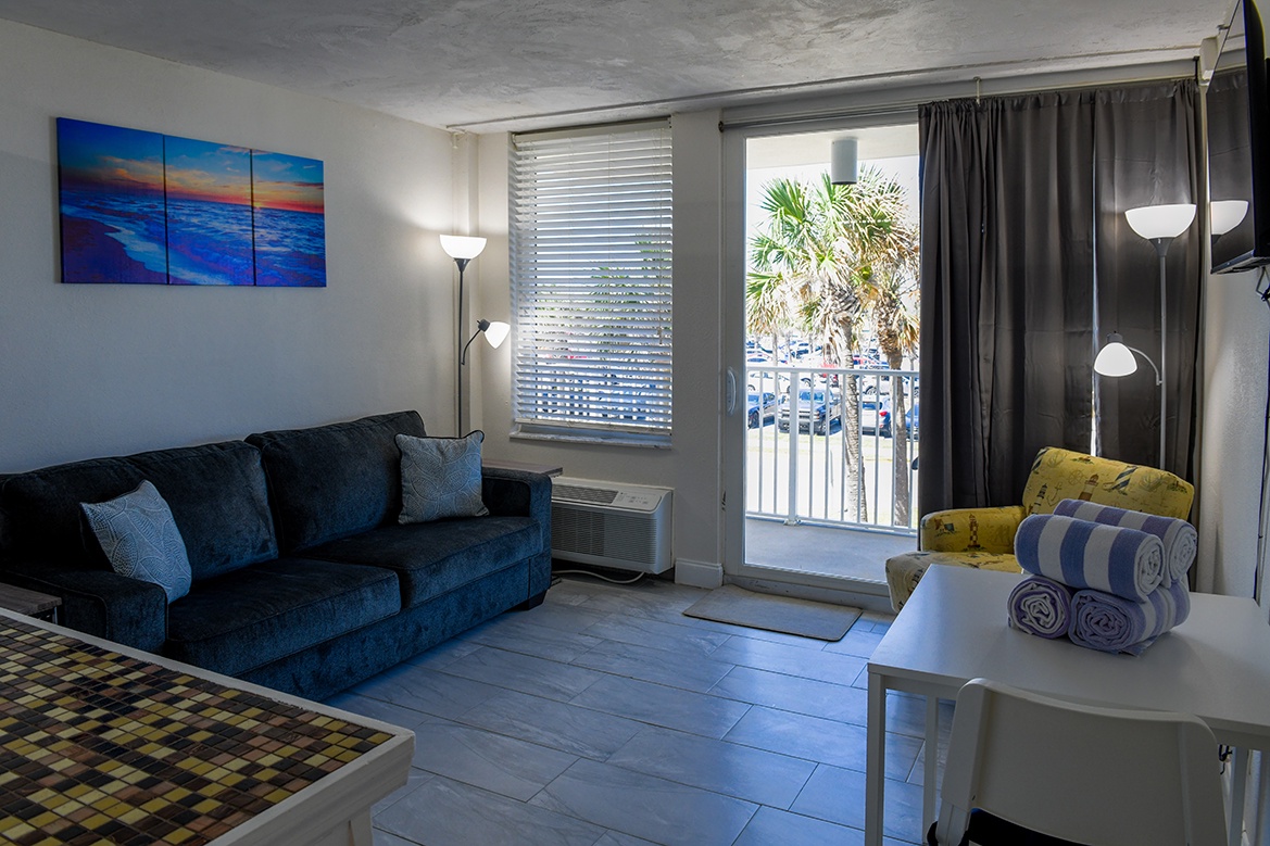 Unwind on your plush sofa while ocean breezes drift through your private balcony doors.