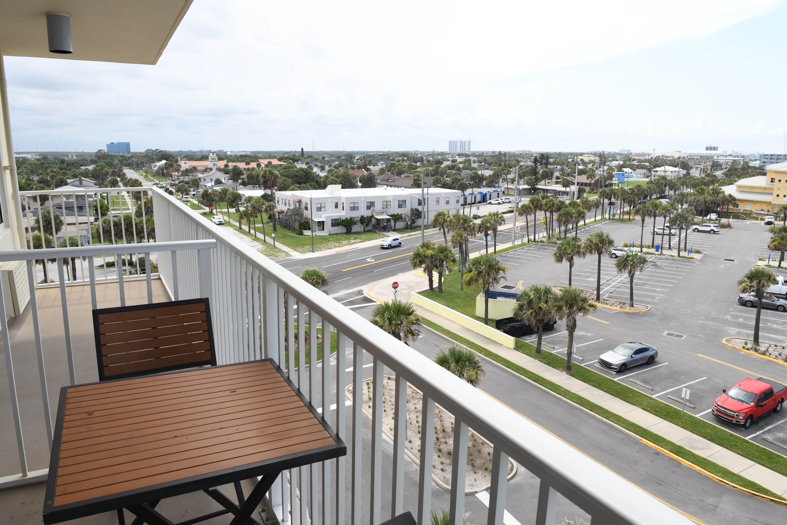Palm-lined streets and open sky stretch out before you from this private balcony—a perfect spot for morning coffee or watching the neighborhood come to life below.