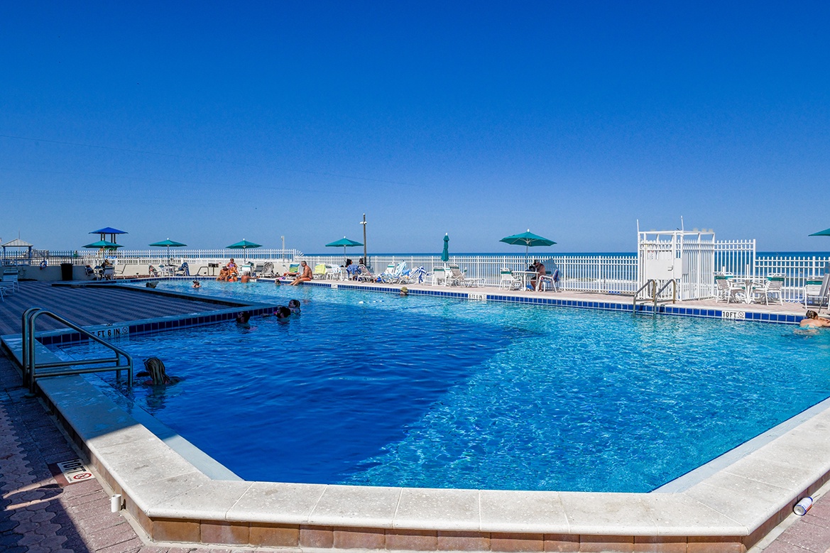 Sparkling pool with crystal-clear blue water invites you to dive in and soak up the sun.