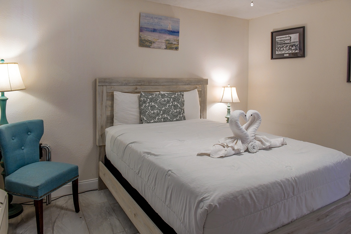 Sink into crisp white linens and enjoy the thoughtful touches like decorative towel swans in your peaceful bedroom retreat.